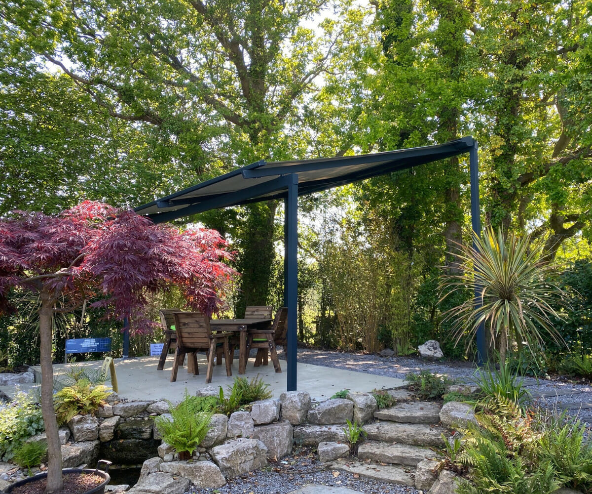A pergola in a wooded garden