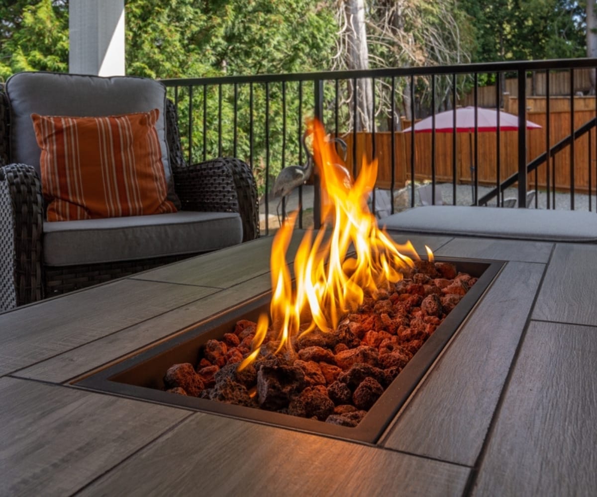 A fire pit under an awning outdoors in winter
