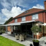 A GBA Awning outside an attractive redbrick house