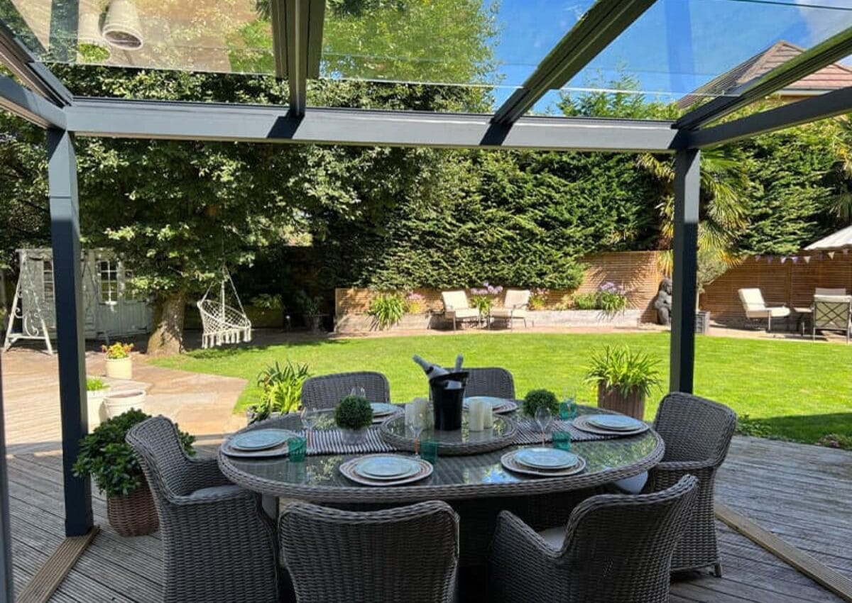 A VELARIUM retractable glass awning in a summers' garden.