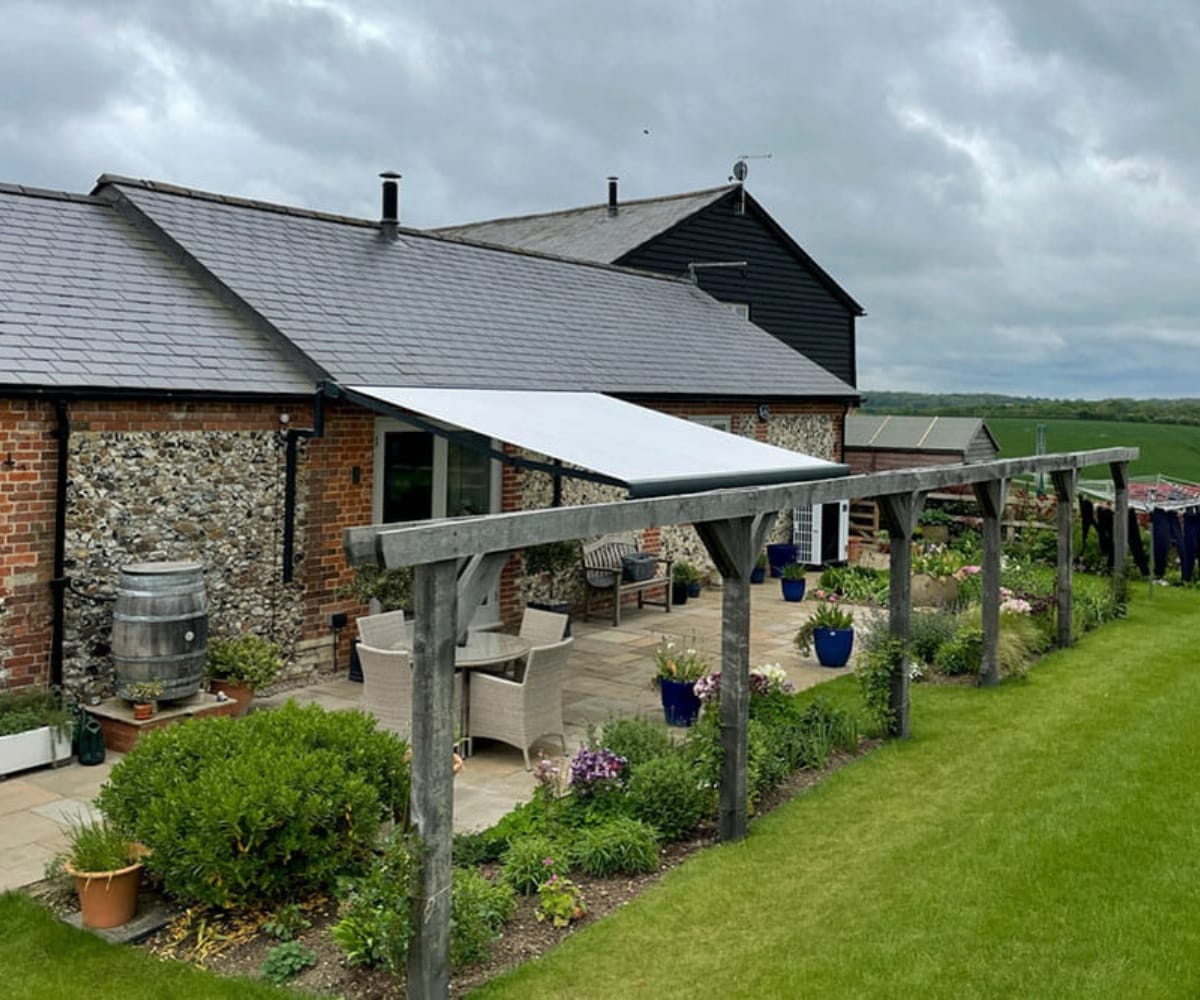 An awning on the outside of a rural house as fitted by Great British Awning and Blind Company TM