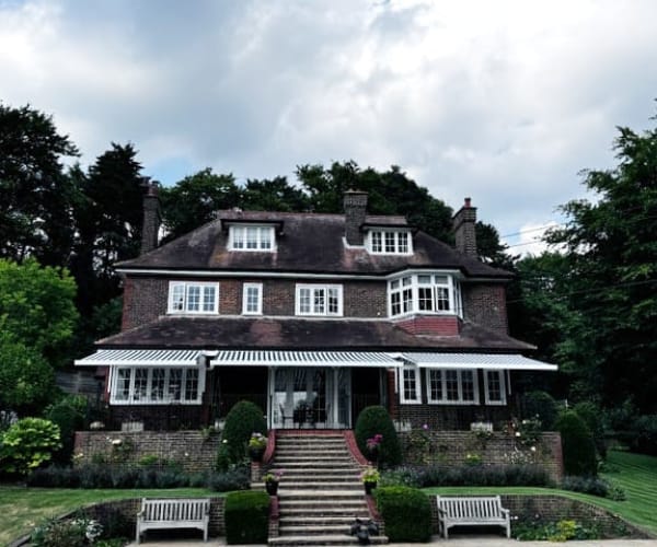 A large house with an awning as installed by Great British Awnings