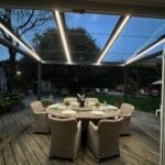 A glass veranda as installed by great british awnings in a winter evening