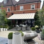 An awning on the front of a redbrick house installed by Great British Awnings