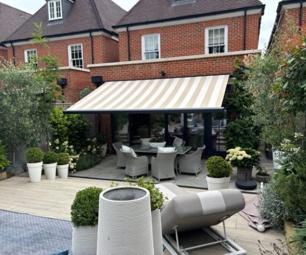 An awning on the front of a redbrick house installed by Great British Awnings