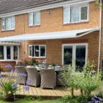 A Great British retractable electric awning professionally installed in a beautiful garden