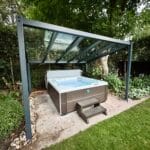 Glass veranda installed over a hot tub in a private garden
