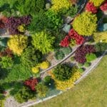 Garden zoning: curved landscaped garden bed with colourful shrubs and layered planting creating defined outdoor zones
