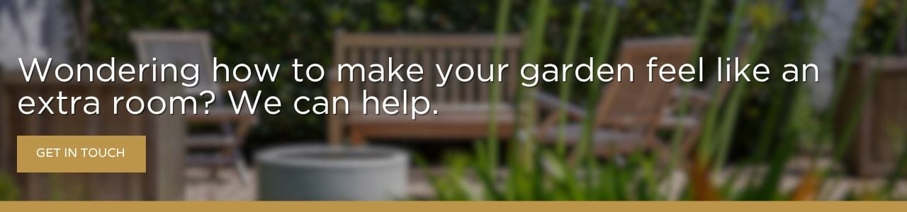Wondering how to make your garden feel like an extra room? We can help: A banner advertisement with blurred garden furniture and lush greenery in the background, featuring white text and a gold-outlined "Get in Touch" button.