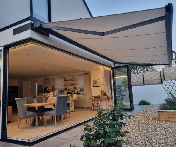 fade-resistant awning fabric: an image of an awning installed by the great british awning and blind company above a tasteful garden room (inline)